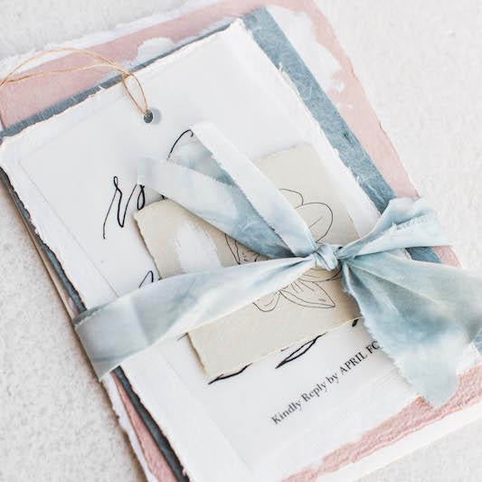 High quality fancy invitation wrapped in light blue ribbon