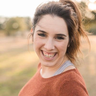 Christina Scalera in high ponytail smiling big in nature
